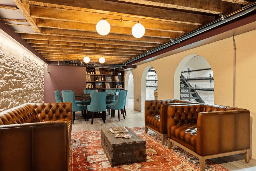 Finished basement with exposed beams and leather seating
